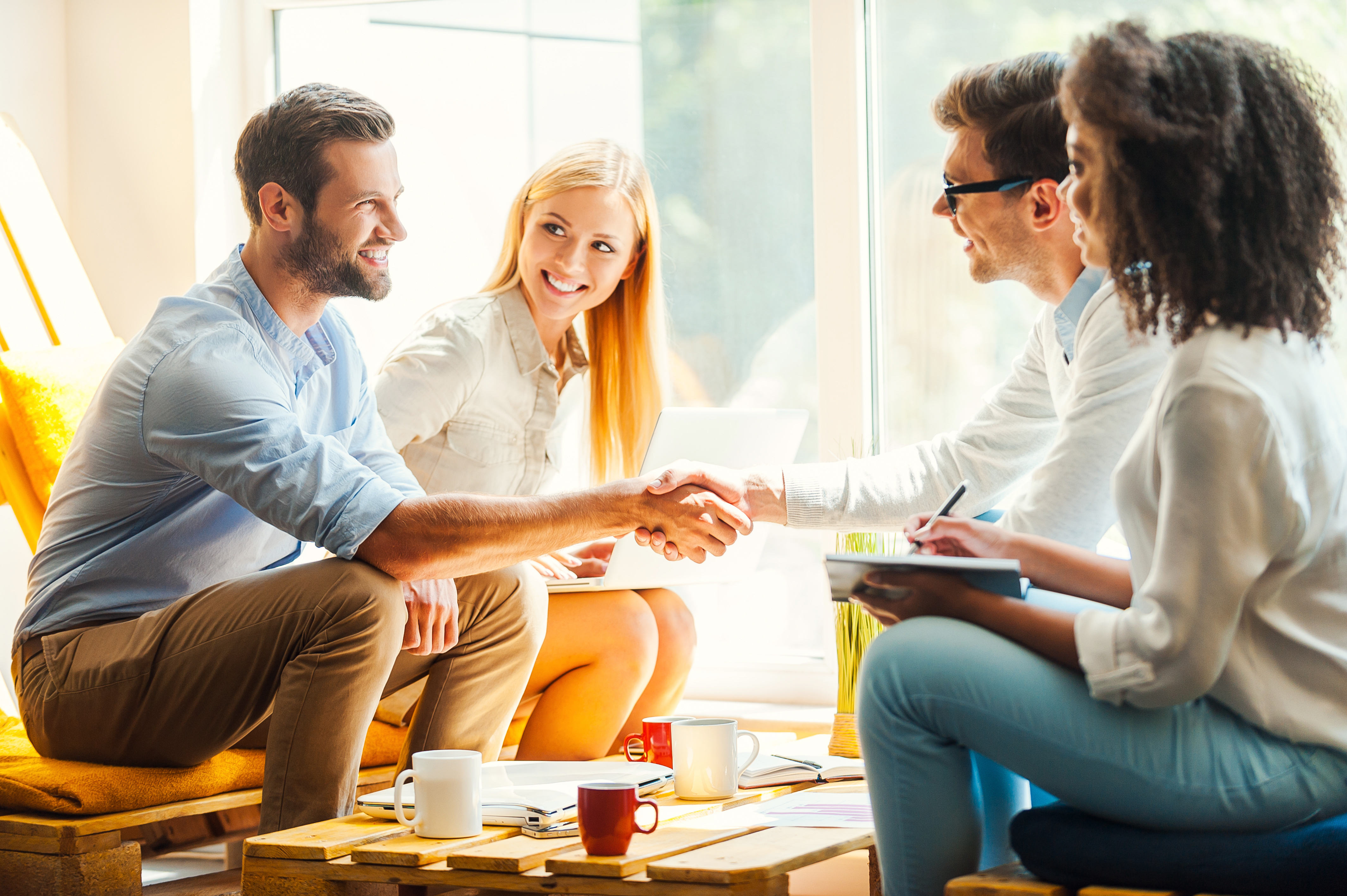 People casually meeting sitting on couch with coffee table