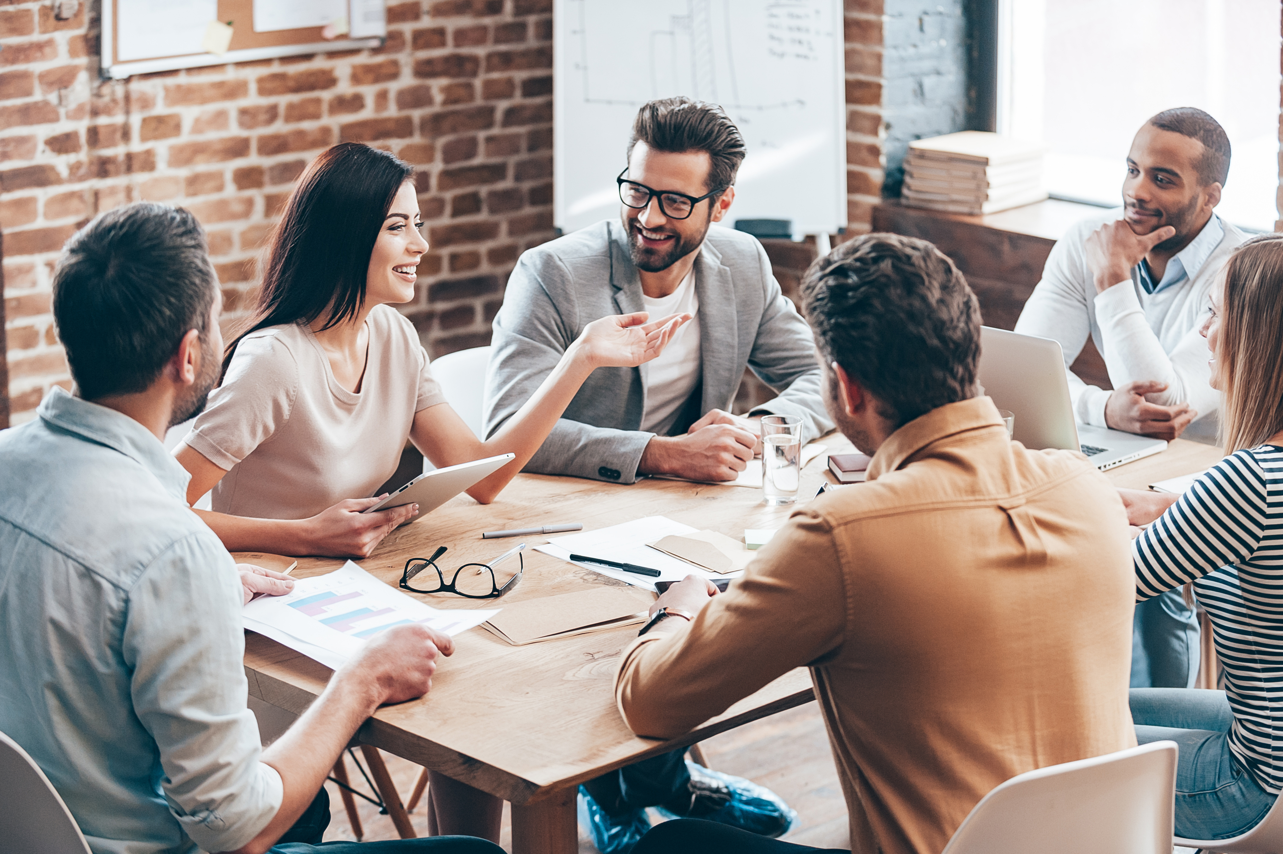 Employee group business meeting at table